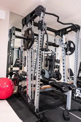 a gym with several tread machines and a ball at Family Retreat Hot Tub Banff and Calgary DT Access in Calgary