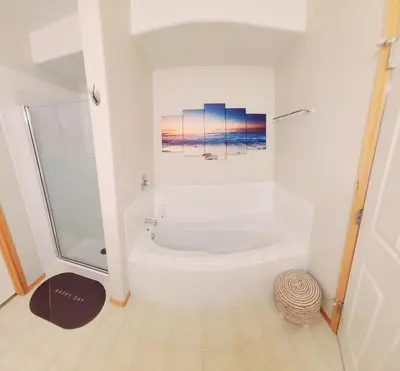 a bathroom with a shower and a bath tub at Family Retreat Hot Tub Banff and Calgary DT Access in Calgary