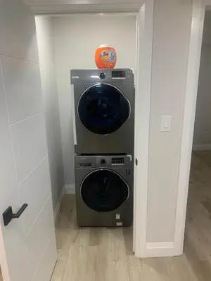 a washer and dryer in a room at Beautiful one Bedroom Bsmnt suite with sep Entrance in Edmonton