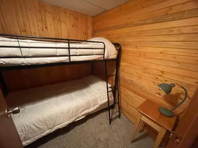 a room with two bunk beds in a wooden wall at Lakeview Mountain Retreat - Private, Modern, Fun in Windermere