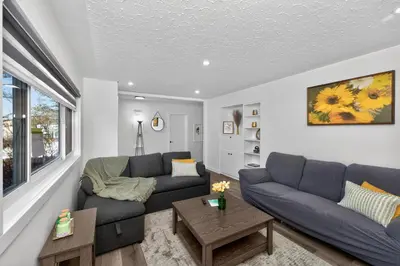 a living room with two blue couches and a table at NEW 2BR Near Downtown Calgary - Private Entry - Airport Access - 4412 UP in Calgary