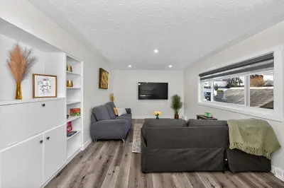 a living room with a couch and a tv at NEW 2BR Near Downtown Calgary - Private Entry - Airport Access - 4412 UP in Calgary