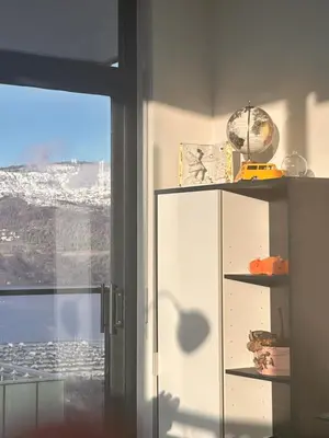 a white cabinet with a view of a city from a window at Signature Iconic Lakeview Downtown 2-Bedroom Loft in Kelowna