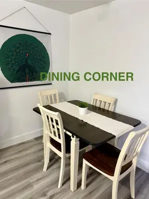 a dining room table and chairs in a room at Cozy 1-Bed Basement Suite in Calgary