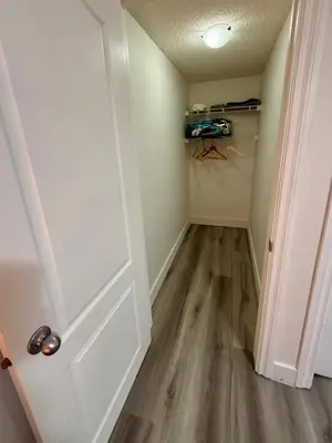an empty room with a door and a closet at Cozy 1-Bed Basement Suite in Calgary