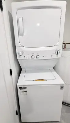 a white washer and dryer in a room at Private 1BR Suite with Kitchen, Laundry, Parking & 1 Gigabit Internet in Whitehorse