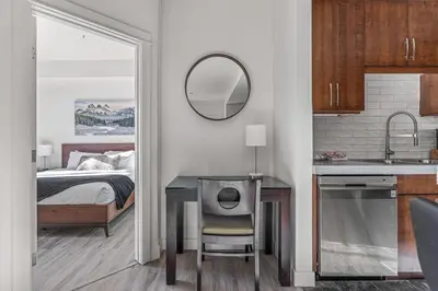a bedroom with a bed and a table with a mirror at Serene 2BR Hideaway Hot Tub and Breathtaking Views in Canmore