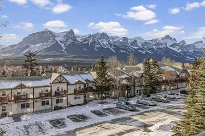 arial view of a town with snow covered mountains at Serene 2BR Hideaway Hot Tub and Breathtaking Views in Canmore
