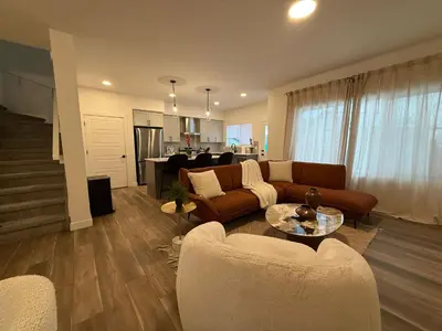 a living room with a couch and a table at Fort Home in Fort Saskatchewan