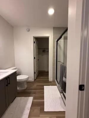 a bathroom with a toilet and a sink and a shower at Fort Home in Fort Saskatchewan
