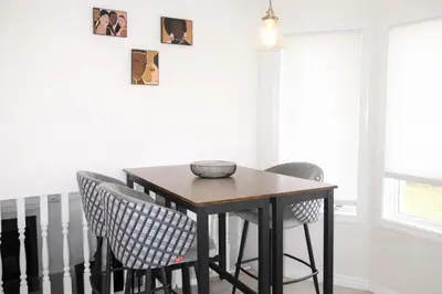 a dining room table and chairs in a room at 4-Level Split Home in Southeast Edmonton in Edmonton