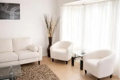 a living room with a couch and two chairs and a table at 4-Level Split Home in Southeast Edmonton in Edmonton