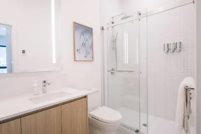 a bathroom with a shower and a toilet and a sink at Ridgeline Penthouse by Revelstoke Vacations in Revelstoke