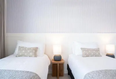 two beds in a room with two lamps at Powder and Par Penthouse by Revelstoke Vacations in Revelstoke