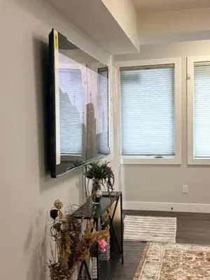 a living room with a flat screen tv on the wall at Stylish Open Cozy & Contemporary Living Space in Prince George