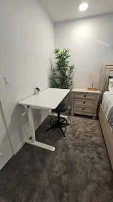 a white desk in a bedroom with a bed at 3 Bedroom Modern Luxury House - Family Friendly, 3 Queen Beds, Free Wi-Fi, and Free Parking in Calgary