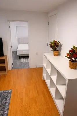 a living room with white shelves and a bedroom at Amalak Homes' Private 2BR Guest Suite North Delta in Delta