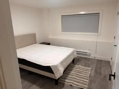 a small bedroom with a bed and a window at Amalak Homes' Private 2BR Guest Suite North Delta in Delta