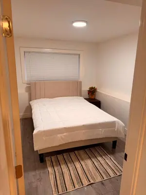 a bedroom with a bed and a window at Amalak Homes' Private 2BR Guest Suite North Delta in Delta