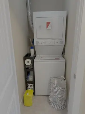 a white refrigerator with a computer on top of it at Cozy 2 Bdrm suite in the Heart of Renfrew Heights in Vancouver