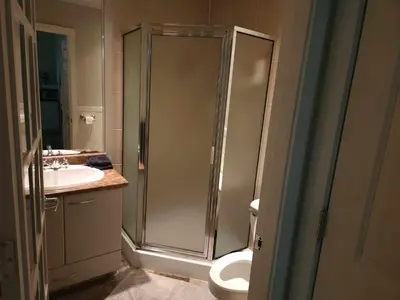 a bathroom with a shower and a toilet and a sink at Vancouver Townhouse Modern 2-Bedroom Retreat in the Heart of Downtown in Vancouver
