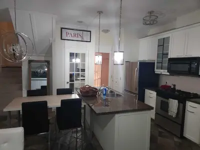 a kitchen with a sink and a counter top at Vancouver Townhouse Modern 2-Bedroom Retreat in the Heart of Downtown in Vancouver