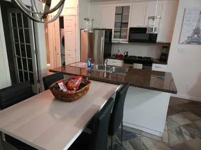 a kitchen with a table with a basket on it at Vancouver Townhouse Modern 2-Bedroom Retreat in the Heart of Downtown in Vancouver