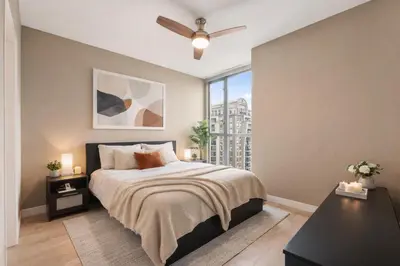a bedroom with a bed and a window at Bright and Comfortable 2BR Downtown Apartment for Families and Groups in Vancouver