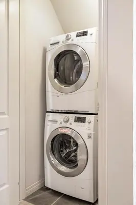 a washer and dryer in a laundry room at Panorama Hills Cozy Guest Suite in Calgary