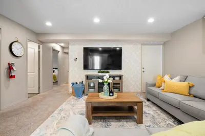 a living room with a couch and a table at Panorama Hills Cozy Guest Suite in Calgary