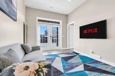 a living room with a couch and a tv at 2 Bedroom Smart Secondary Suite with Gazebo view in Calgary