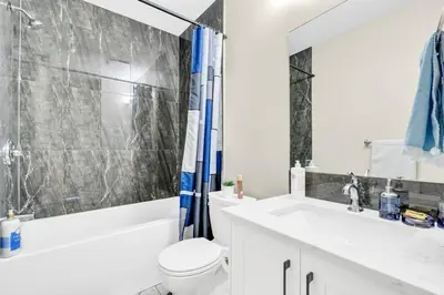 a bathroom with a toilet and a sink and a shower at 2 Bedroom Smart Secondary Suite with Gazebo view in Calgary