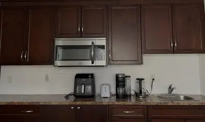 a kitchen with a counter top with a microwave at Private Suite in Airdrie Near Calgary Free Parking in Airdrie