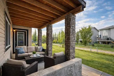 an outdoor patio with wicker chairs and a table at Private Suite in Airdrie Near Calgary Free Parking in Airdrie