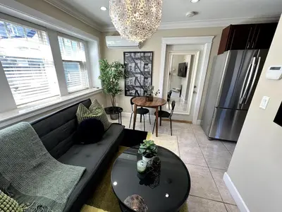 a living room with a couch and a table at A Cozy Nest, Private Tiny Home in Vancouver