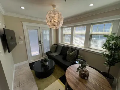 a living room with a couch and a table at A Cozy Nest, Private Tiny Home in Vancouver