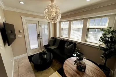 a living room with a couch and a chandelier at A Cozy Nest, Private Tiny Home in Vancouver