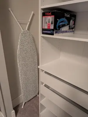 a walk in closet with a white cabinet with drawers at Designer 2-Bedroom Garden-Level Walk-Out Suite in Surrey