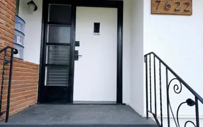 a door on a building with a sign on it at Bohemian Theme Private Room near Metrotown Mall with private parking in Burnaby