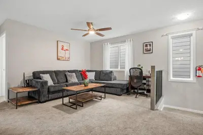 a living room with a couch and a ceiling fan at Bright & Spacious Family Retreat in Calgary