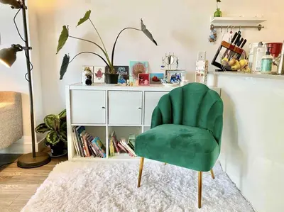 a green chair sitting in front of a white cabinet at 25 Days Minimum - Luxury and Modern Downtown Apartment - Do not send request for less than 21 days in Vancouver