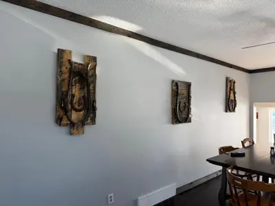 a dining room with white walls and a table at Cowboy Cabin- Lakefront Rental Northern Saskatchewan