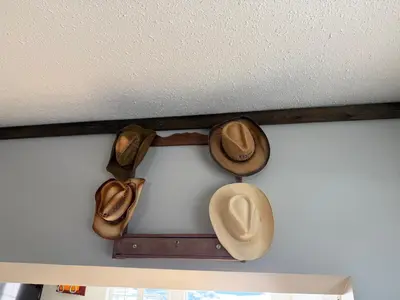 a group of cowboy hats hanging on a wall at Cowboy Cabin- Lakefront Rental Northern Saskatchewan