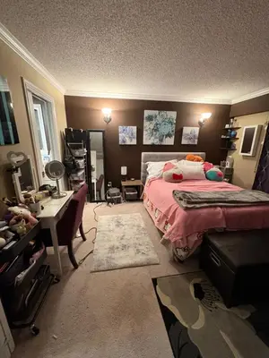 a bedroom with a bed and a desk in it at Oasis in Surrey