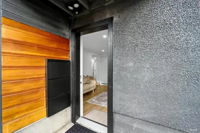 a sliding glass door in a room with a living room at Shanaz house in Vancouver