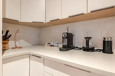 a kitchen counter with a coffee maker on it at Modern Bright Suite Self Check-In in North Vancouver