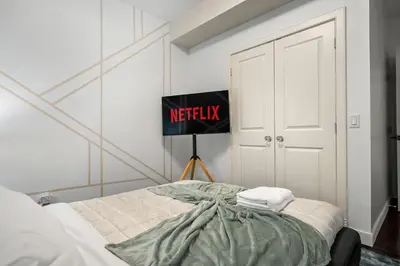 a bedroom with a bed with ametix sign on the wall at Luxury Haven | Pool | Hot Tub & Sauna |Outdoor BBQ in Calgary
