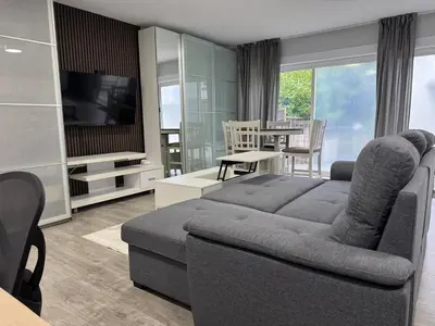 a living room with a couch and a television at Super bright and beautiful home with all you need in Delta
