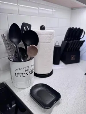 a kitchen counter with a cup of utensils at Rosie Cozy Retreat in Victoria