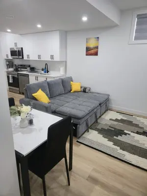 a living room with a couch and a table at Mayfair Suite in Airdrie
